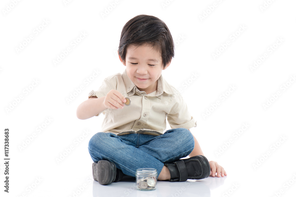 Cute Asian child saving money in glass bottle,money saving concept Cute Asian child saving money in glass bottle,money saving concept