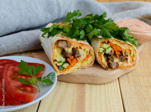 Shawarma - Middle East (Arabic) dish of pita (lavash) stuffed with: grilled meat, sauce, vegetables