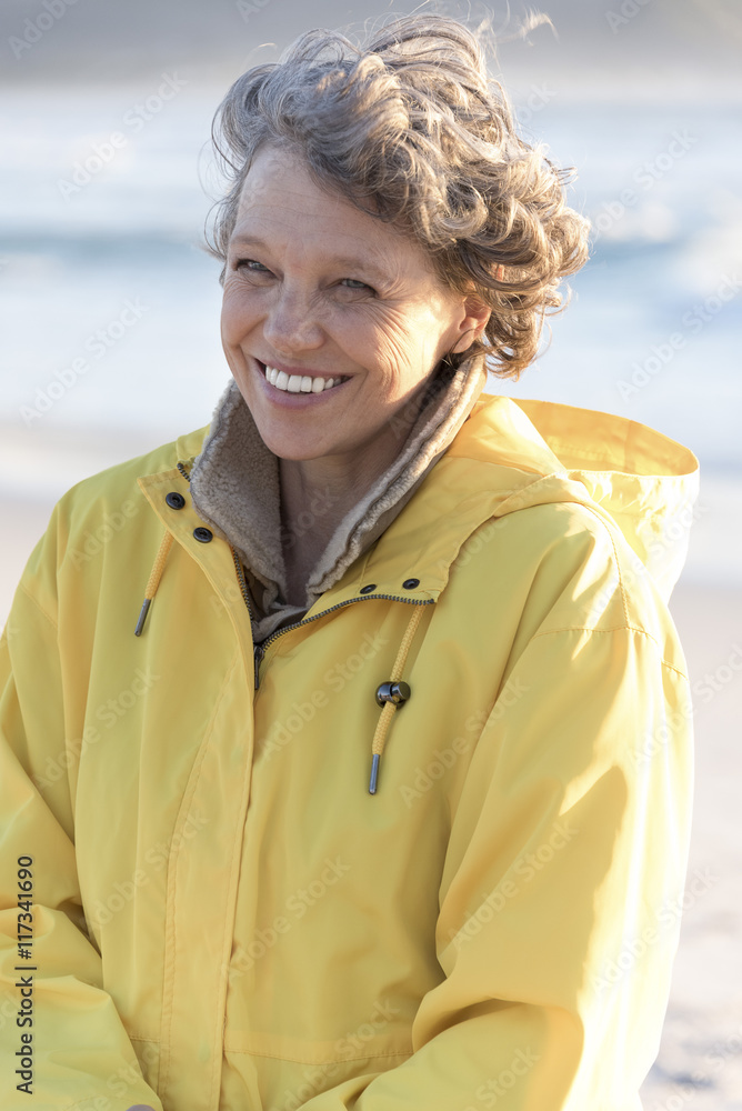 Portrait of happy mature woman smiling on the beach Portrait of happy mature woman smiling on the beach