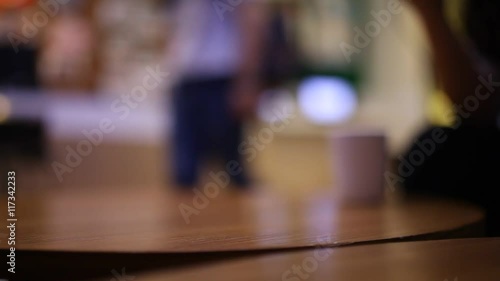 Wallpaper Mural The people play mobile and tablet on the table at cafe blurred background Torontodigital.ca