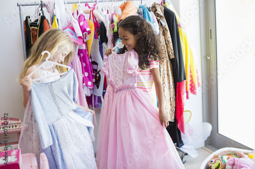 Two little girls trying on clothes photo