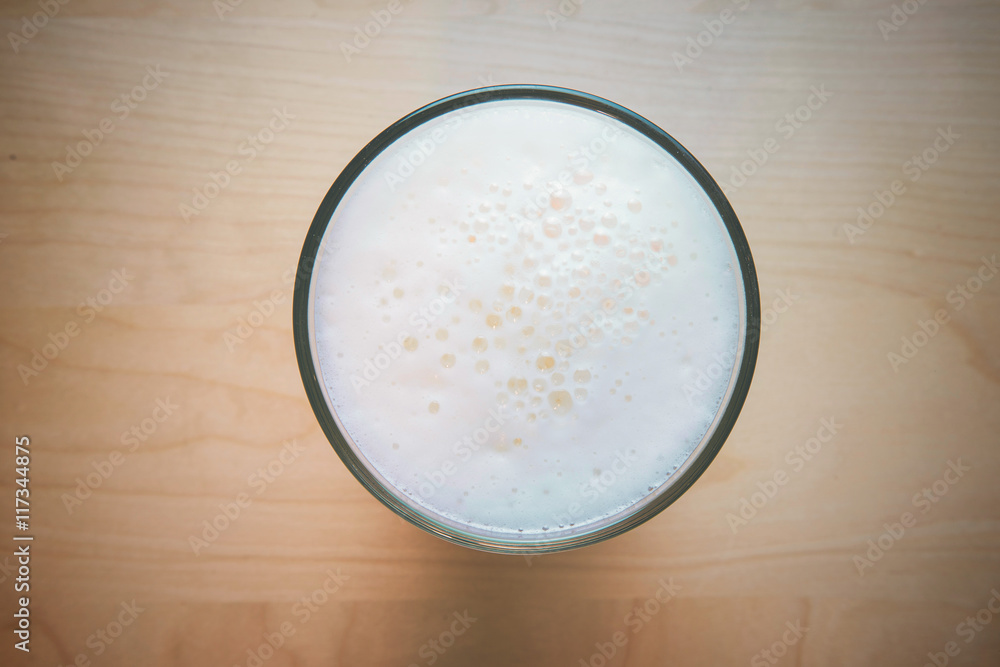Glass of fresh lager beer on wooden table. vintage color Glass of fresh lager beer on wooden table. vintage color