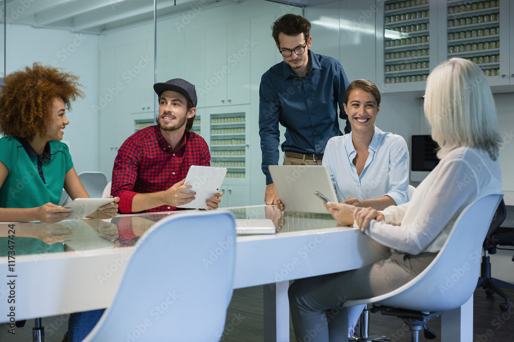 Happy business people discussing in meeting