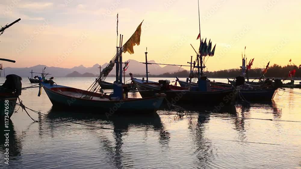 Group of fishing boat anchored at Pranburi beach in Thailand, taken on twilight sunset scene Group of fishing boat anchored at Pranburi beach in Thailand, taken on twilight sunset scene