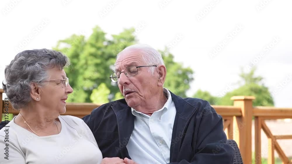Portrait of elderly couple relaxing outside senior home Portrait of elderly couple relaxing outside senior home