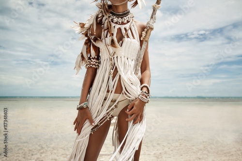 Attractive wild boho woman at beach