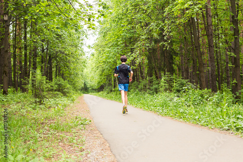 Athletic young man running in the nature. Healthy lifestyle © satura_