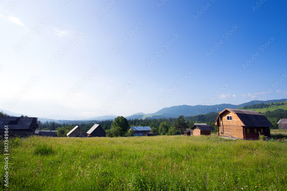 wooden houses on a grass hills wooden houses on a grass hills