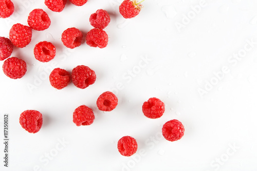 Red fresh raspberries on white background