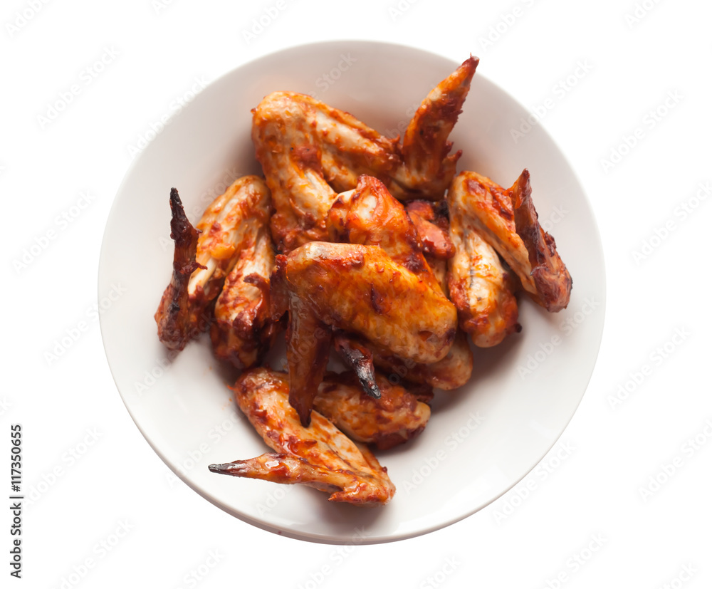 Grilled spicy chicken wings in white dish. Chicken wings isolated on white background.