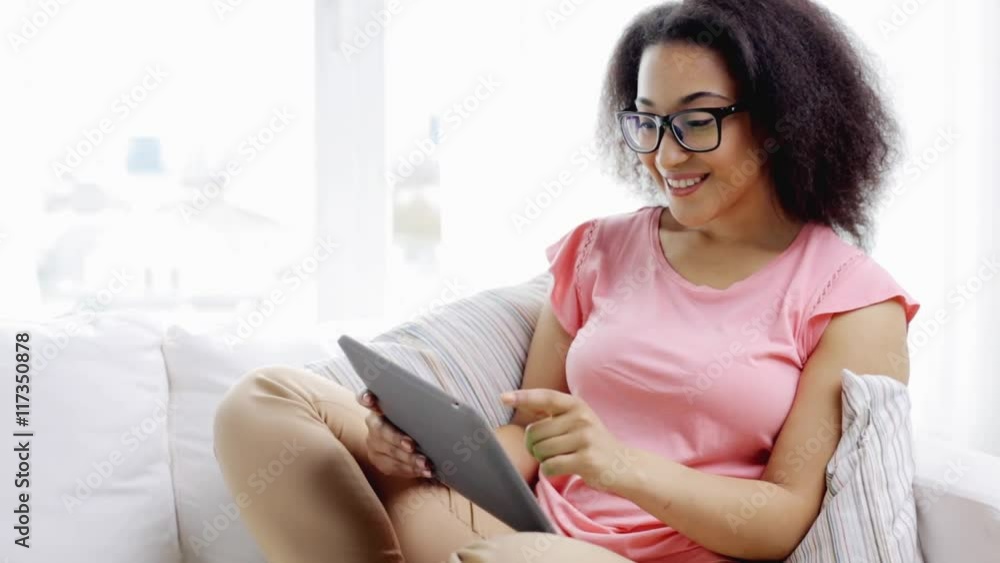 african american woman with tablet pc at home