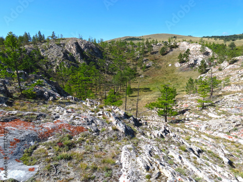 Sinkhole on Lake Baikal. The territory of Pribaikalsky National Park. At the bottom near the water is the famous rock Sagan-Zaba with petroglyphs. 