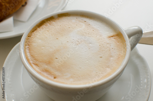 The cup of cappuccino with foam