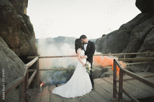 Wallpaper Mural Gorgeous bride, groom kissing and hugging near the cliffs with stunning views Torontodigital.ca