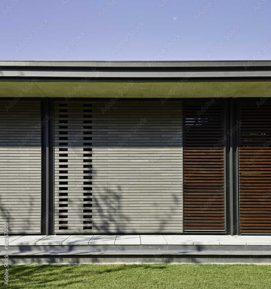 Back of house with wood slatted walls in white and red wood. Back of house with wood slatted walls in white and red wood.