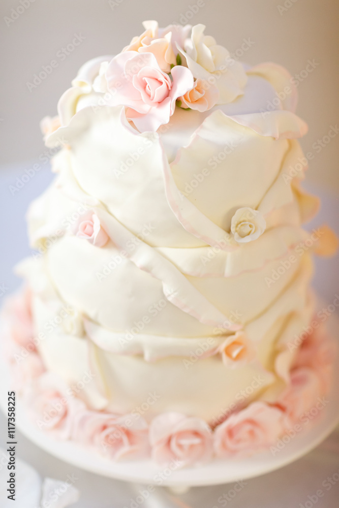 Perfect wedding cake decorated with pink glaze roses Perfect wedding cake decorated with pink glaze roses