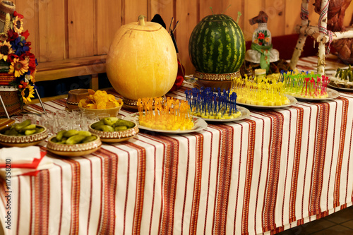 Pickled vegetables and cheese stand lie in serving dishes on a b photo