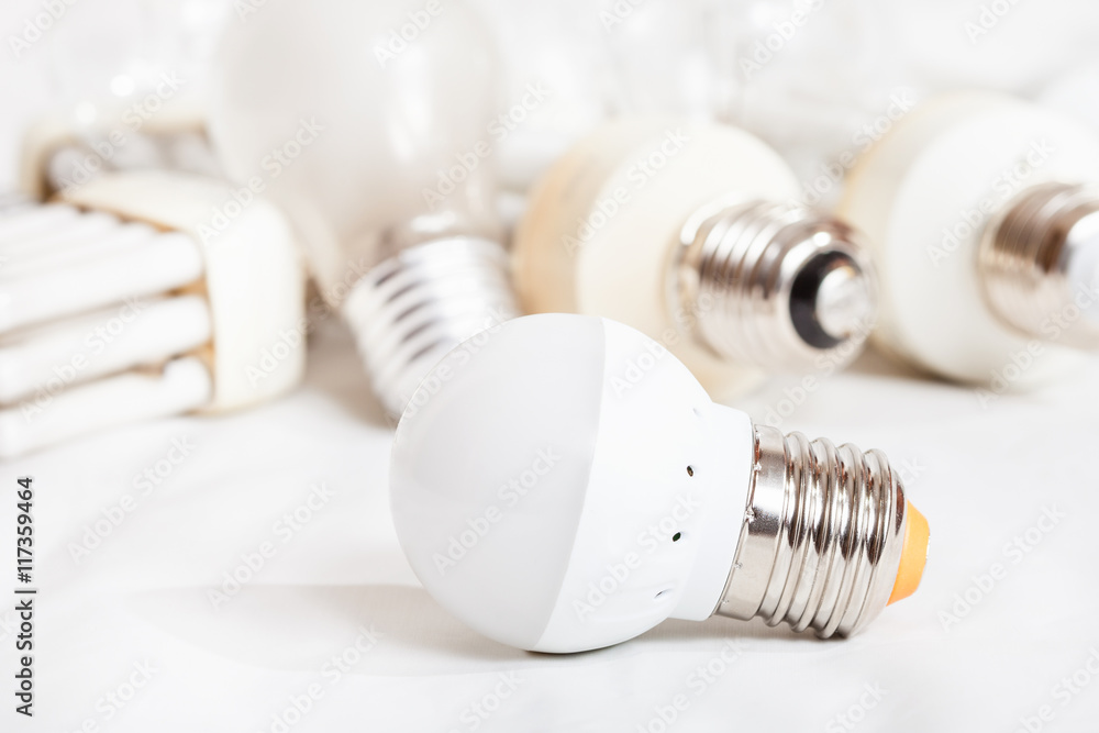 energy saving LED lamp and several old light bulbs energy saving LED lamp and several old light bulbs
