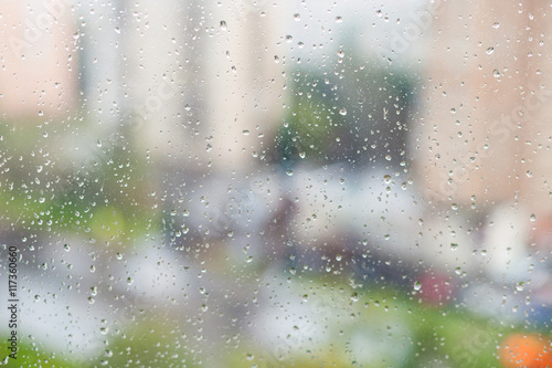 raindrops on window and blurred houses