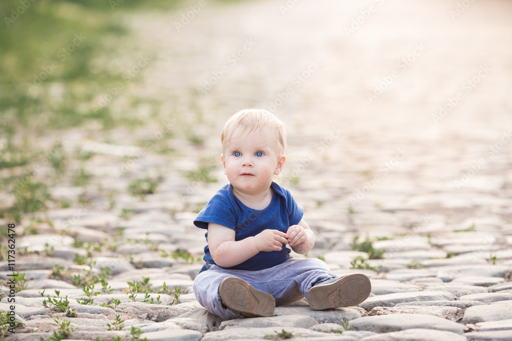 Happy laughing girl on grass. Smiling one child outdoors Happy laughing girl on grass. Smiling one child outdoors