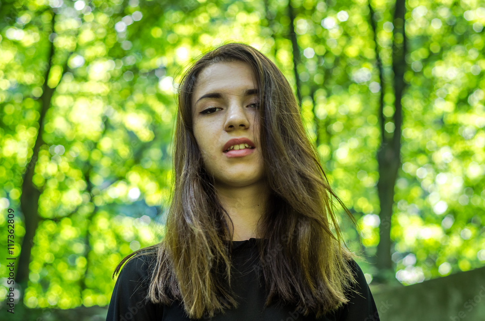 Young beautiful teenager girl with hair dlinnіmi Strіyskom walks in the park in Lviv Young beautiful teenager girl with hair dlinnіmi Strіyskom walks in the park in Lviv
