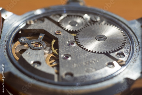 Vintage wristwatch's back with out case.The movement reveals gears, main spring, balance wheel, jewels and etc.