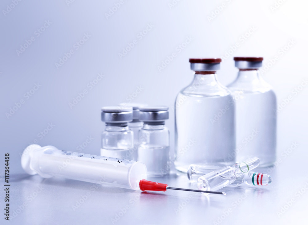 Vials and syringe, studio shot. Medical objects for vaccination. Vaccine drew up into a syringe. 
