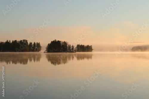 Fototapeta Naklejka Na Ścianę i Meble -  Sunrise on the lake with haze.