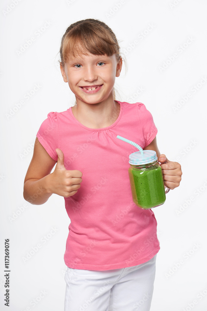 Girl holding jar tumbler mug with green smoothie drink Girl holding jar tumbler mug with green smoothie drink