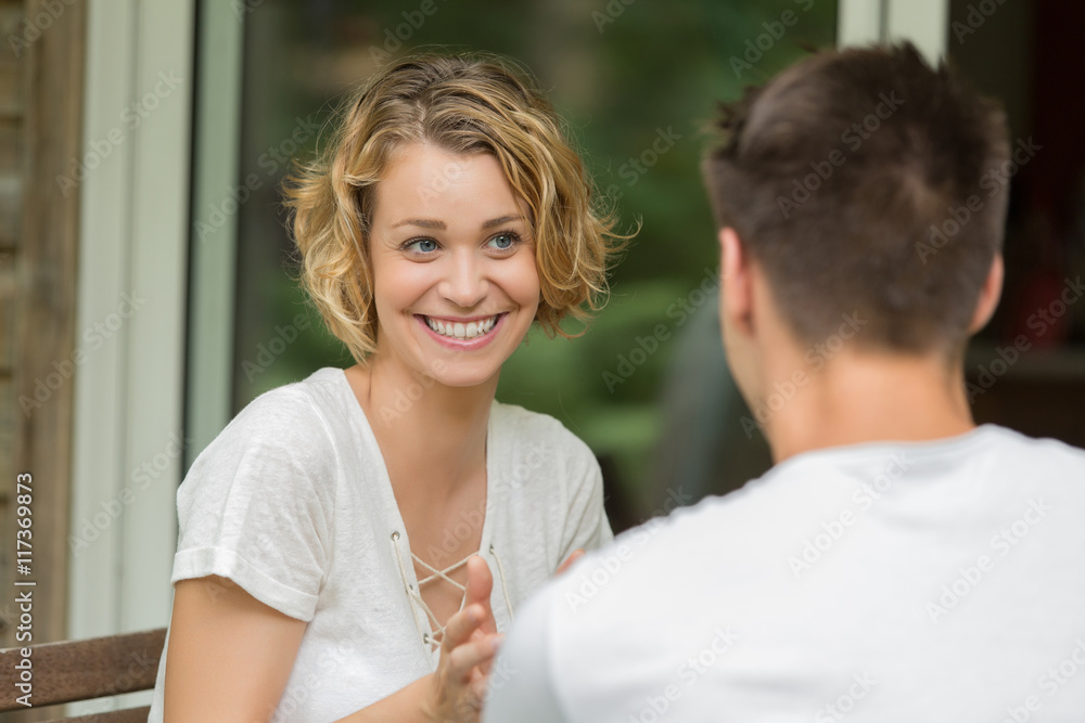 Fototapeta premium young couple sitting at a table and speaking