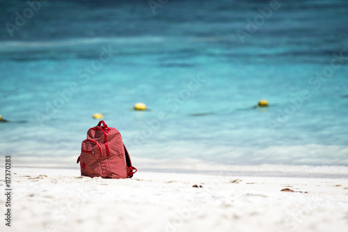 red bag on the beach