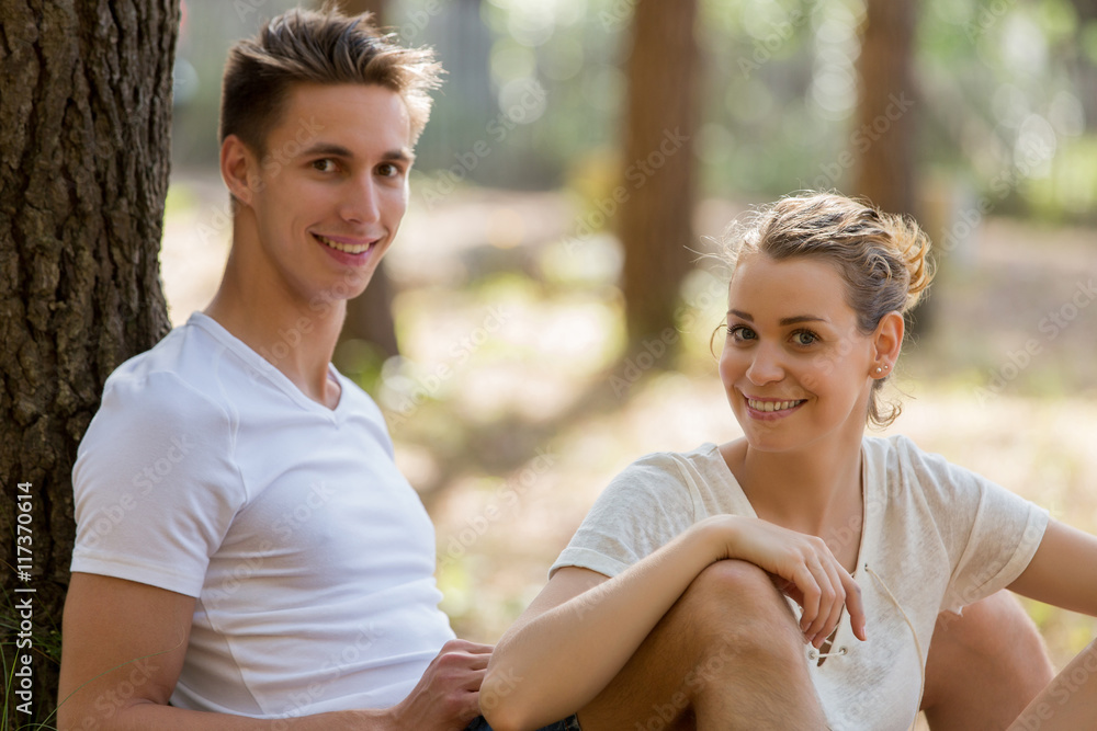 young lovers resting in forest young lovers resting in forest