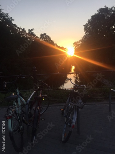 Bicyles on a parking near river bank in Wroclaw photo