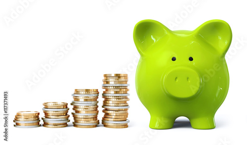 Green piggy bank with coin stacks in ascending order photo