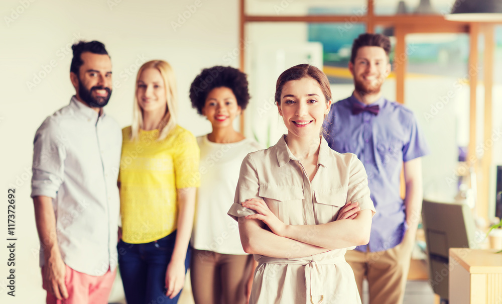 happy young woman over creative team in office happy young woman over creative team in office