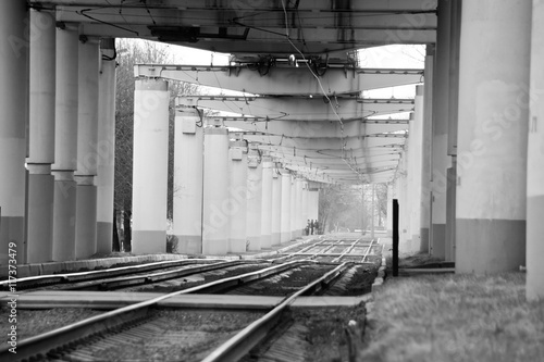 rails under the bridge black and white