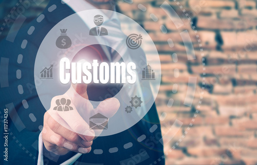 Photography A businessman selecting a Customs Concept button on a circular panel