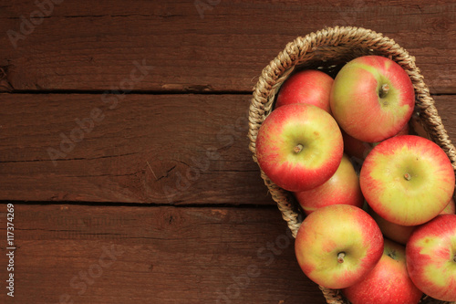 Apples in a basket on wooden background