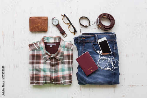 Men's casual outfits with man clothing and accessories on rustic wooden background, travel concept