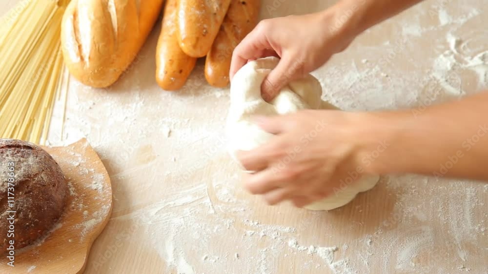 Man hands kneading dough in flour on table. Man hands kneading dough in flour on table.