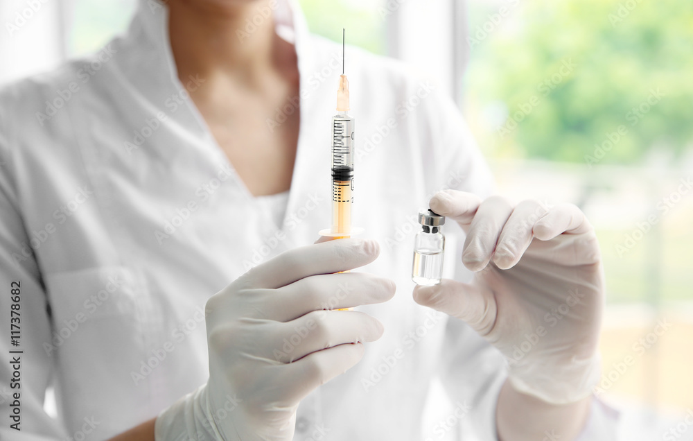 Hands in gloves with syringe Hands in gloves with syringe