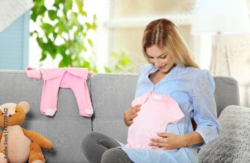 Pregnant woman with baby cl...