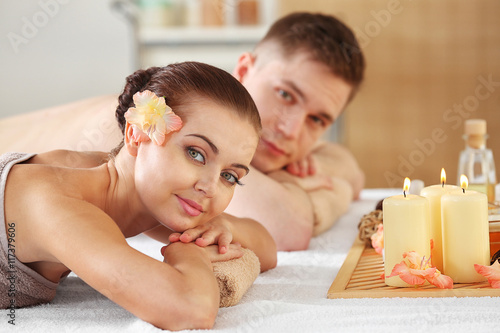 Handsome man and beautiful girl relaxing in spa salon