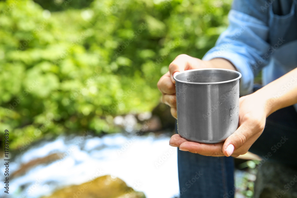 Girl relaxing with drink in forest Girl relaxing with drink in forest