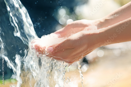 Water dropping from woman's hands
