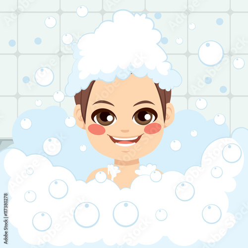 Adorable little boy having fun washing hair with foam soap on head