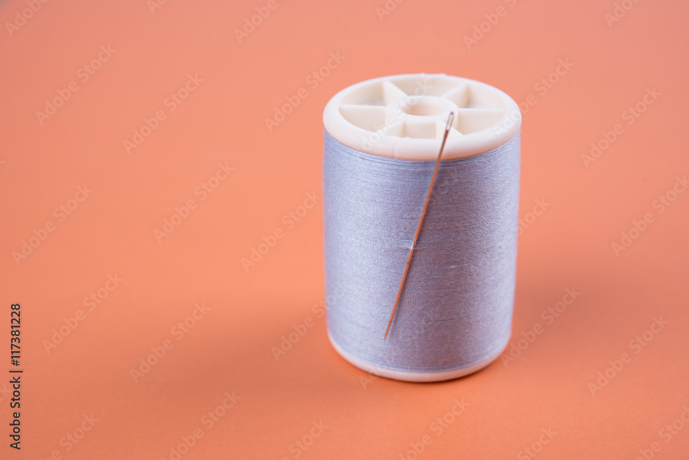 closeup needles, thread spool on wooden background. closeup needles, thread spool on wooden background.