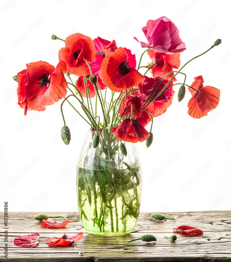 Fototapeta premium Bouquet of poppy flowers in the vase on the wooden table.