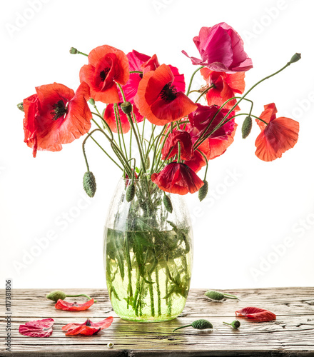 Fototapeta Naklejka Na Ścianę i Meble -  Bouquet of poppy flowers in the vase on the wooden table.
