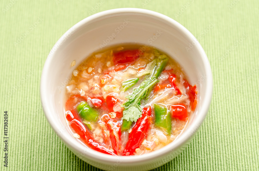 Thai spicy seafood dipping sauce on green background Thai spicy seafood dipping sauce on green background